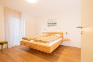 a bedroom with a wooden bed in a room at Ferienhof Haas in Friedrichshafen