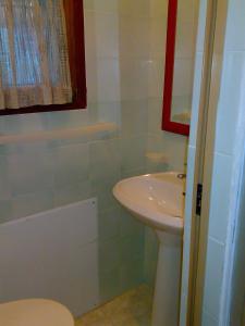 a bathroom with a sink and a toilet at Ianua Coeli 2 in Mosso Santa Maria