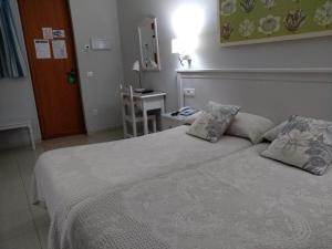 Cama o camas de una habitación en Hotel Goya