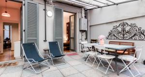 une terrasse avec une table et des chaises. dans l'établissement ALTIDO Apt for 6 with Big Terrace in Milan Centro Storico, à Milan