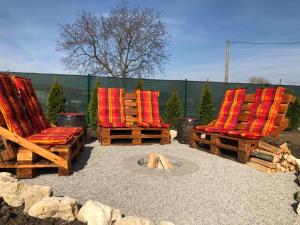 a group of chairs sitting next to a fire pit at Apartmány Milovice in Milovice