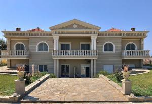 a large house with a driveway in front of it at Villa Dimitri - Beach House in Alexandroupoli