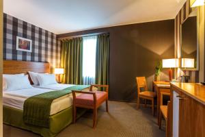 A bed or beds in a room at Eurostars Sofia City