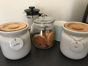 a counter with two toasters and some bread in jars at The Grange Silverstone in Towcester