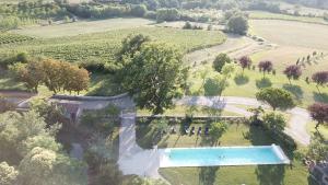 an overhead view of a swimming pool in a field at Le Castel Pierre - 7ch&7sdb avec clim, piscine XL, salle fitness et sauna pour 18 personnes in Lagraulet-du-Gers