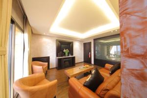 a living room with a couch and chairs and a table at Sunrise Hotel in Jounieh