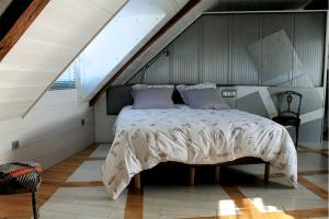 a bedroom with a bed in a attic at Le Chêne creux in Sucé