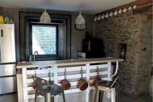 a kitchen with a counter with pots and pans on it at Le Chêne creux in Sucé