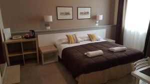 Postel nebo postele na pokoji v ubytování Hotel Arianna
