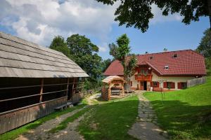 a barn and a farm house with a fence at Farmstay&Glamping Visočnik in Ljubno