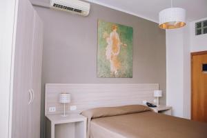 Postel nebo postele na pokoji v ubytování Hotel Piccolo Sogno