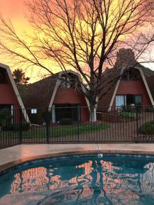 a house with a tree and a swimming pool at Red Agave Resort in Sedona