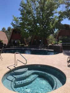 a swimming pool with a hot tub in a yard at Red Agave Resort in Sedona
