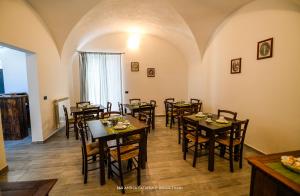a restaurant with wooden tables and chairs in a room at Antica Catania Accomodation in Catania