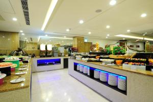 a restaurant with a buffet line with plates and food at Hoya Resort Hotel in Hualien City +20 photos
