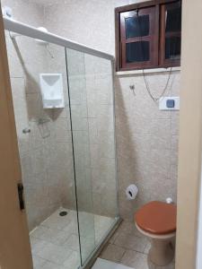 a bathroom with a glass shower with a toilet at HOTEL POUSADA ALAGOINHAS in Alagoinhas