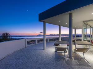 a house with a view of the ocean at dusk at Attico Belvedere sul mare in Su Forti