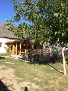 a house with a tree in front of it at Teraszos ház in Balatonlelle