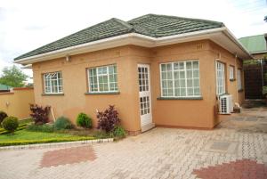 a small house with a tile roof at Lonjeta Self-Catering Apartments in Lilongwe