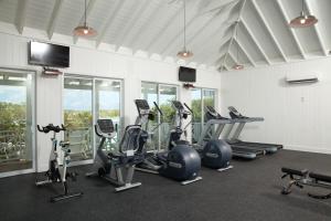 a gym with several treadmills and elliptical machines at Kahari Resort, a Peace and Plenty Resort Property in Georgetown