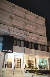 a white building with a sign on the side of it at Relais Peucetia in Gravina in Puglia