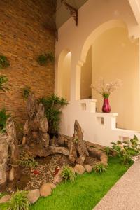 a rock garden in a house with a pond at La Palm Hotel in Hanoi