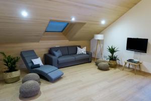 a living room with a couch and a flat screen tv at Appartement Hochsitz in Hochfilzen