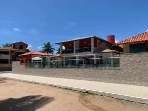 a large house with a balcony in front of it at Summit Pousada Noah in Maceió