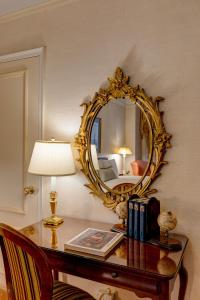 a mirror sitting on top of a wooden table at Hotel Elysee by Library Hotel Collection in New York