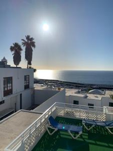 a view of the ocean from the balcony of a house at Las Terricitas Old town Apartment in Puerto del Carmen