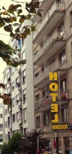 a building with a yellow sign in front of it at Hotel Windsor in Santiago de Compostela