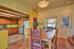 a kitchen and dining room with a wooden table at Spacious Adobe Home Less Than 1 Mi to Downtown Taos! in Taos