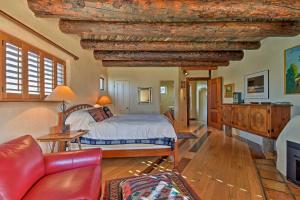a bedroom with a bed and a living room at Spacious Adobe Home Less Than 1 Mi to Downtown Taos! in Taos