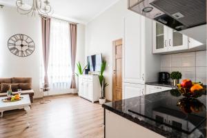 a kitchen and living room with a counter top at El Dorado Apartment z Jacuzzi in Wrocław