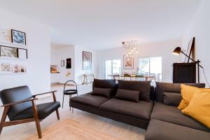 a living room with a couch and a table at Casa Oliva - Olhão in Olhão