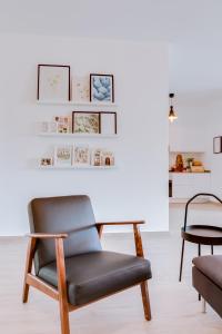 a living room with two chairs and a table at Casa Oliva - Olhão in Olhão