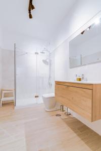 a bathroom with a shower and a sink and a toilet at Casa Oliva - Olhão in Olhão