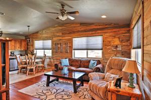 a living room with a couch and a table at Pagosa Springs Escape with Deck, Hot Tub and Grill! in Pagosa Springs
