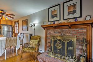 a living room with a fireplace and a table and chairs at Pet-Friendly West Yarmouth Home, Half Mi to Beach! in West Yarmouth