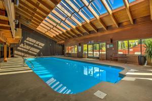 a swimming pool in a building with a ceiling at Walk to Main St Frisco Condo with Community Pool! in Frisco
