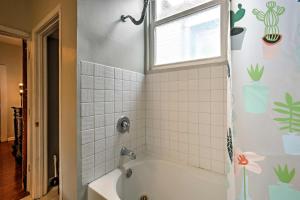 a bathroom with a bath tub and a window at 5 Mi to Bourbon Street Central NOLA Home in New Orleans +17 photos