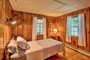 een slaapkamer met houten wanden en een bed in een kamer bij Cape Cod House with Grill and Yard - Drive to Beach! in South Yarmouth