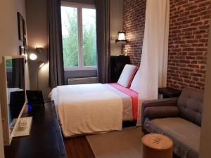 Giường trong phòng chung tại Les Appartements de Champagne