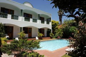 a house with a swimming pool in front of it at Devereux Lodge in East London