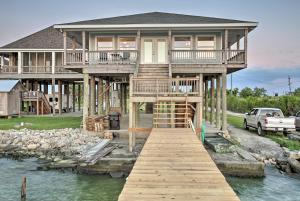 una casa grande con un muelle en el agua en Luxe Waterfront Lake Pontchartrain Home with Dock!, en Venetian Isles