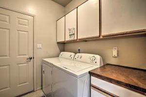 a small kitchen with a white washer and dryer at Adobe House with Patio - 1 half Mi to Santa Fe Plaza! in Santa Fe