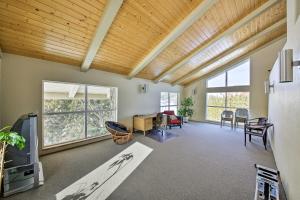 a living room with a wooden ceiling at Lake Pend Oreille Condo with Porch and Mountain View! in Sandpoint