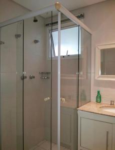 a shower with a glass door in a bathroom at Apartamento em Resort Ilha da Madeira na Riviera in Riviera de São Lourenço