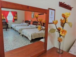 A bed or beds in a room at Hotel D´ Carmona