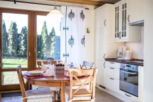 a kitchen with a table and chairs and a window at 4U Apartments - Zakopane in Zakopane